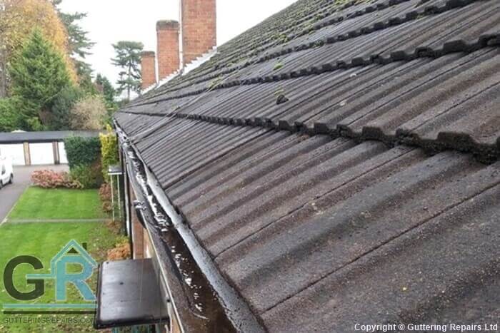 Roof gutter repair and cleaning on residential flats.