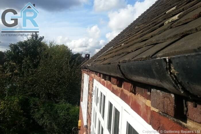 Leaking cast iron roof gutter causing serious structual damage due to the roof gutter being installed directly above the brickwork.